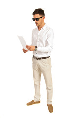 Man with sunglasses reading paper