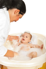 Mother washing her newborn baby