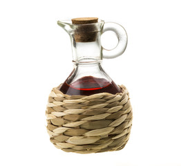 Small decanter with red wine vinegar isolated on the white