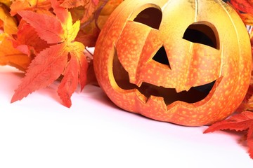 Pumpkin head and colorful leaves on white background
