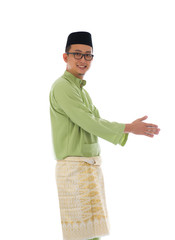 Traditonal Malay man with welcome gesture during ramadan isolate