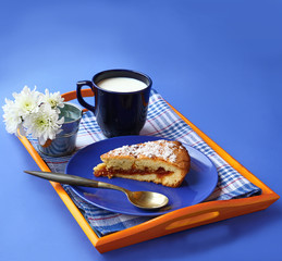 Breton butter cake on a blue plate and a bouquet of  chrysanthem