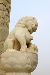 White marble lion sculpture in a park