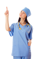 Young female doctor pointing finger upwards