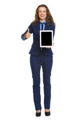Fototapeta premium Full length portrait of smiling business woman showing tablet pc