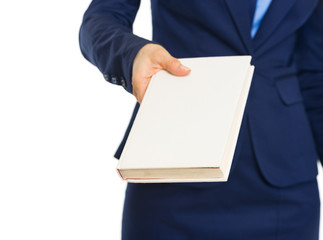 Closeup on business woman giving book