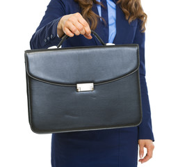 Closeup on business woman giving briefcase