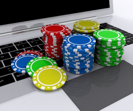 Laptop and casino chips on keyboard