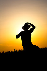 farmer in a field of wheat in the sunset