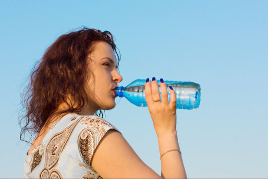 woman drinking water outdoor