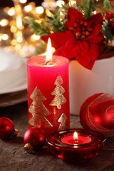 Candles and ornaments on holiday table.