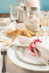 Summer table setting decorated with starfish and sea shell