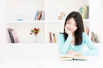 attractive asian woman reading book in the room
