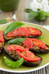 Grilled eggplant with tomatoes and meat.