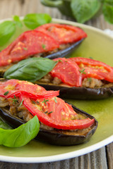 Grilled eggplant with tomatoes and meat.