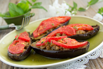 Grilled eggplant with tomatoes and meat.