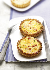 two quiches with bacon on a plate