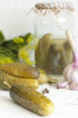 Pickles gherkins salted cucumbers still life on old planks