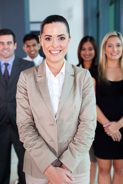 female business leader with team on background