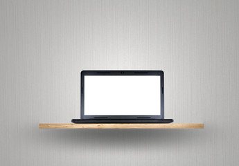 Laptop on wood shelf