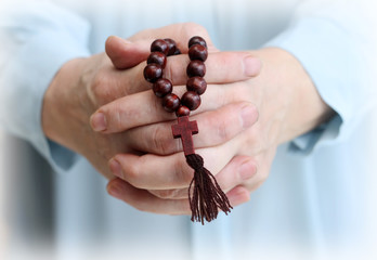 Image of parishioner's hands with wooden rosary