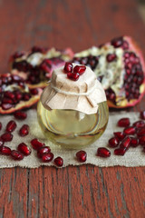 Image of aromatic pomegranate oil in glass bottle