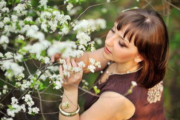 beautiful girl on the nature near flowering trees