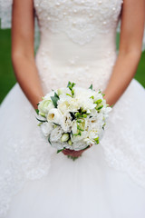 closeup of bride hands holding beautiful wedding bouquet