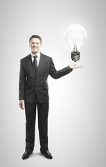 businessman holding lamp