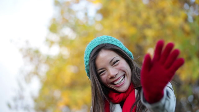 Fall woman waving hello and blowing a kiss