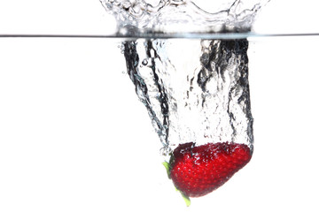 strawberry in the water splash over white