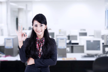 Businesswoman approval gesture at office