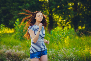 Naklejka na ściany i meble brunette striped runner woman t-shirt young running outdoors, pr