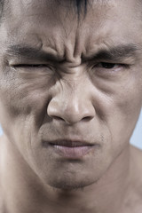 Close up of young mans face, irritated