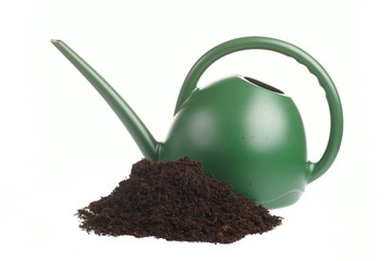 Soil and watering can on white background