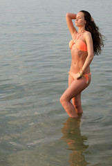Beautiful brunette woman enjoying her time on the beach