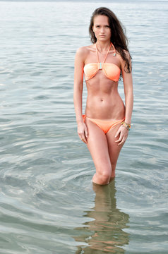 Beautiful brunette woman enjoying her time on the beach