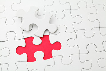 Puzzle with missing piece in red color