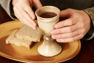 Hands with chalice and bread
