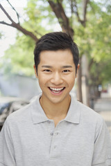 Portrait of young man smiling on City Street