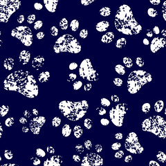 Cat or dog white paw prints on dark blue seamless pattern