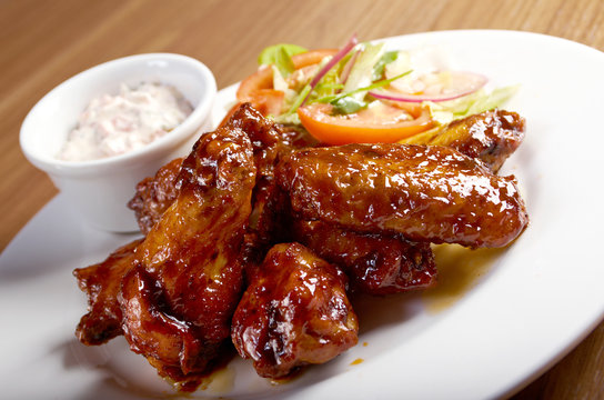 Roasted chicken wings on plate