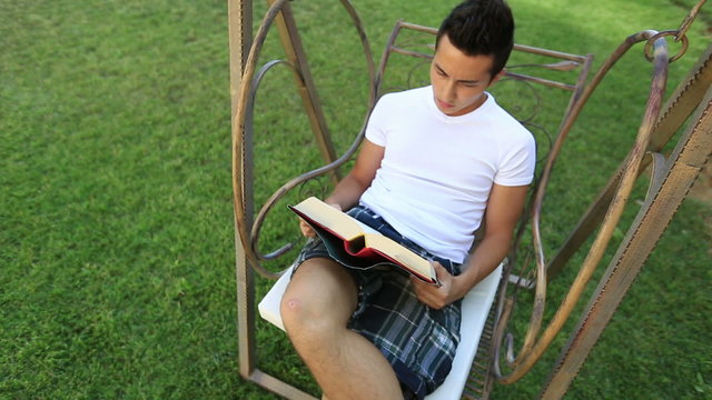 young attractive boy reading book 3