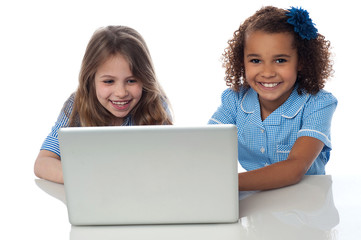 Obraz na płótnie Canvas Exceited school girls with laptop