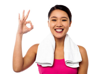 Smiling asian girl showing okay sign