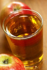 Glass with apple juice and apples.