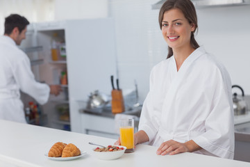 Fototapeta na wymiar Woman having breakfast with cereal and orange juice