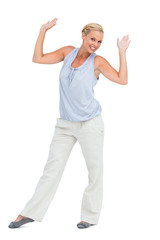 Woman looking at camera and raising hands