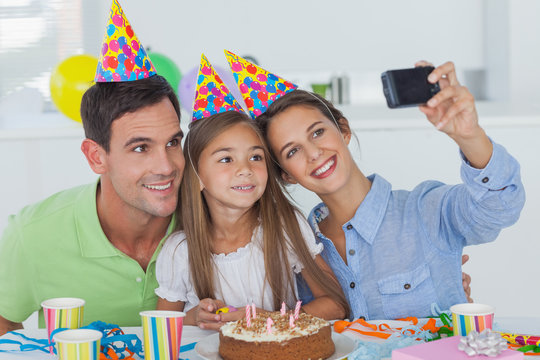 Woman taking pictures of her family during a birthday party