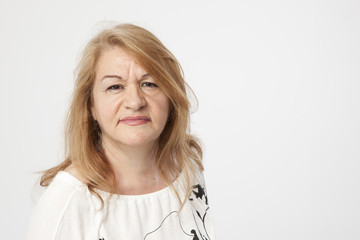 senior woman portait serious expression white background